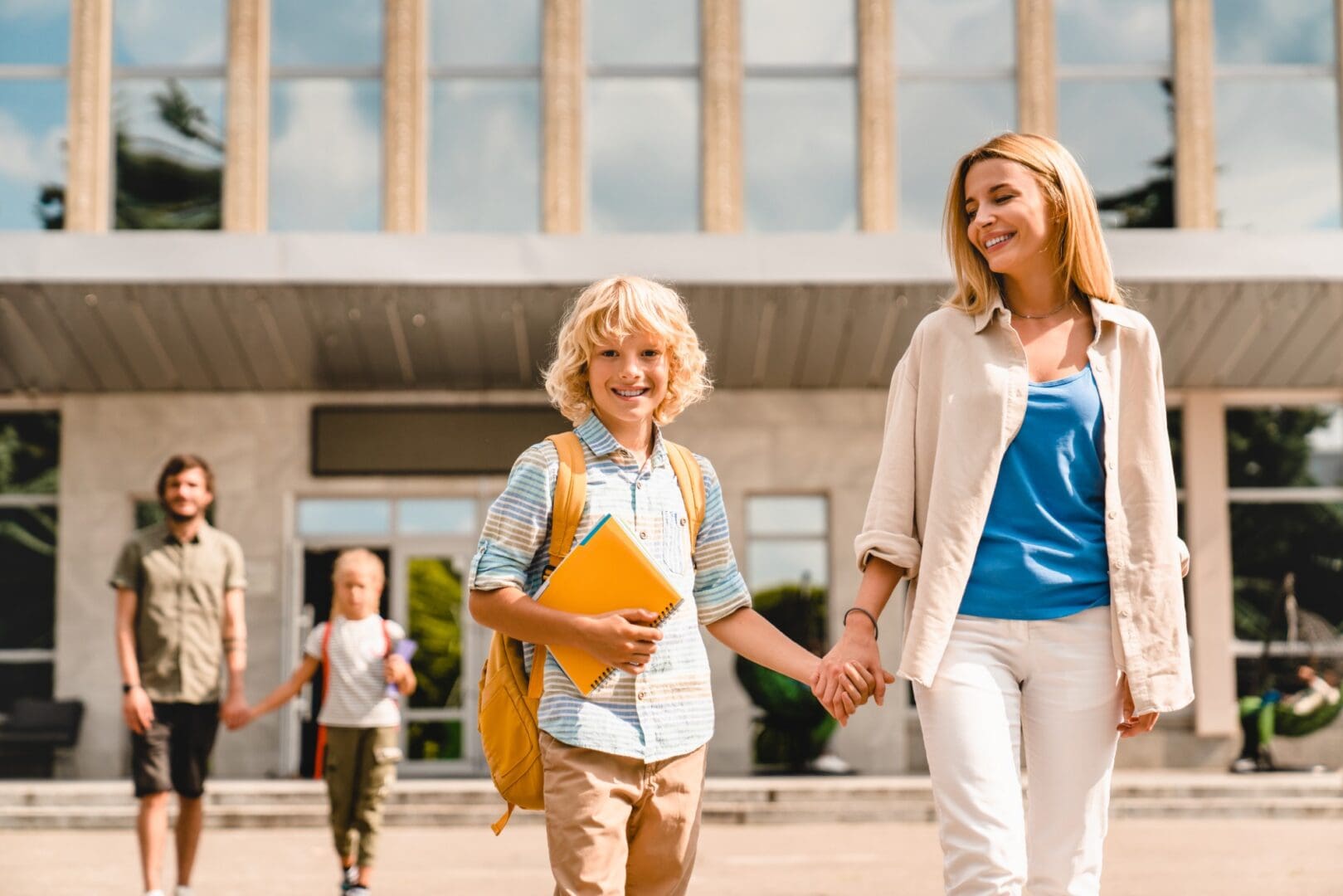 Happy child with backpack and parent