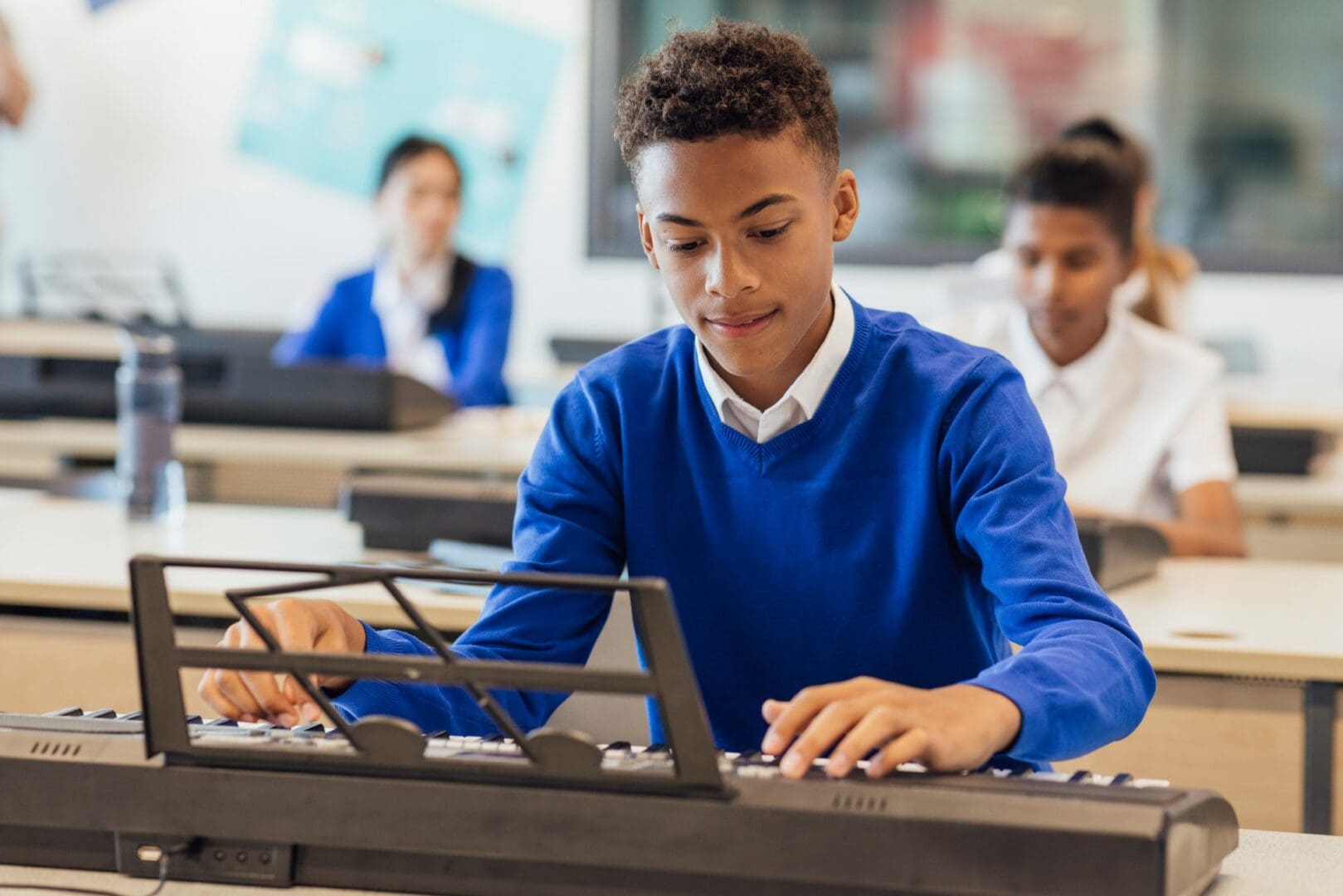 Student playing keyboard in music class