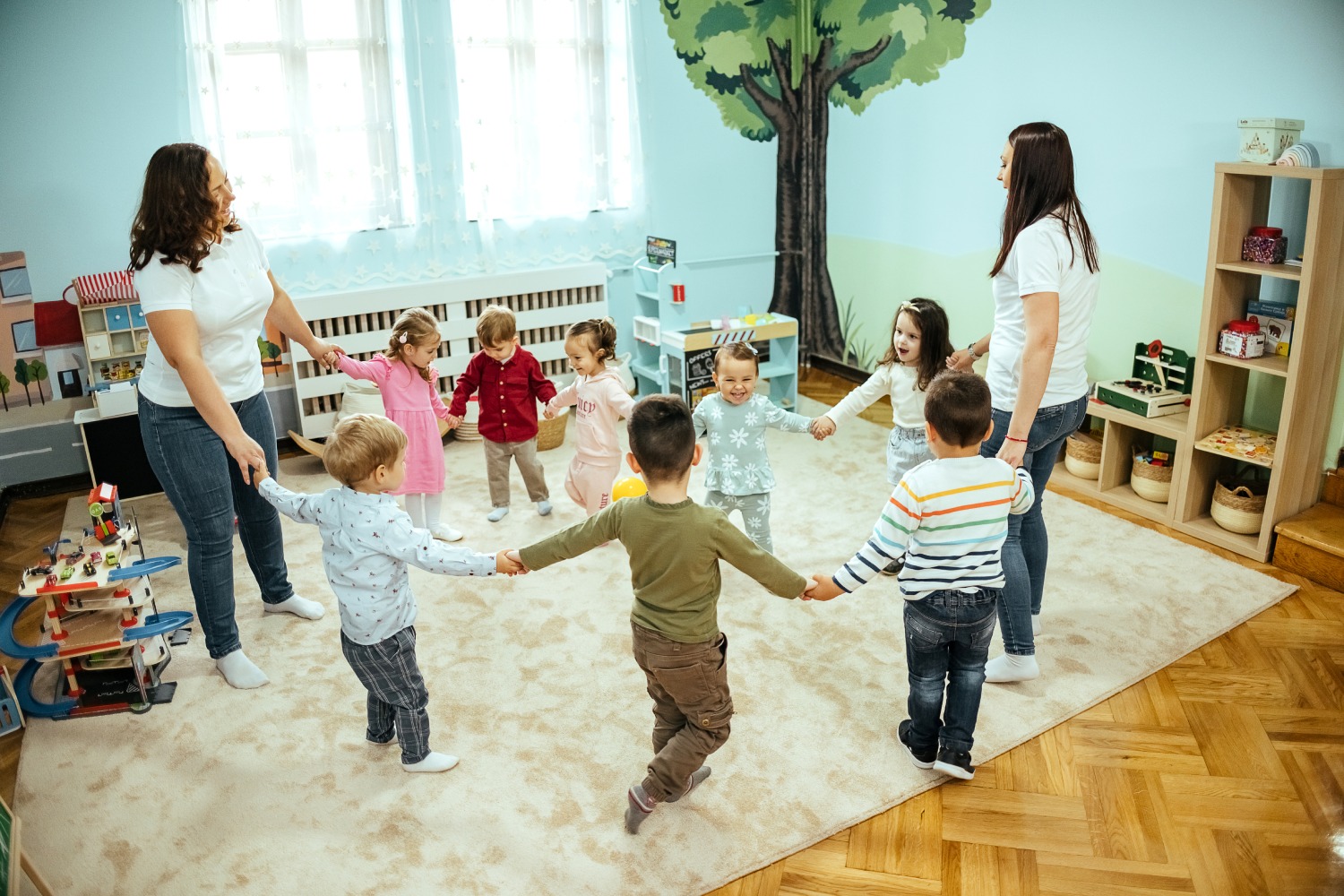 Kids holding hands in a classroom