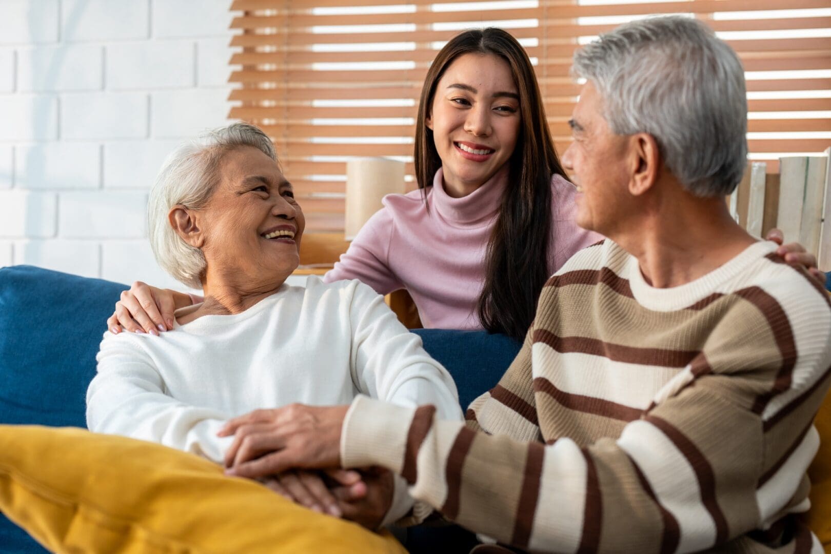 Elderly couple with smiling young woman